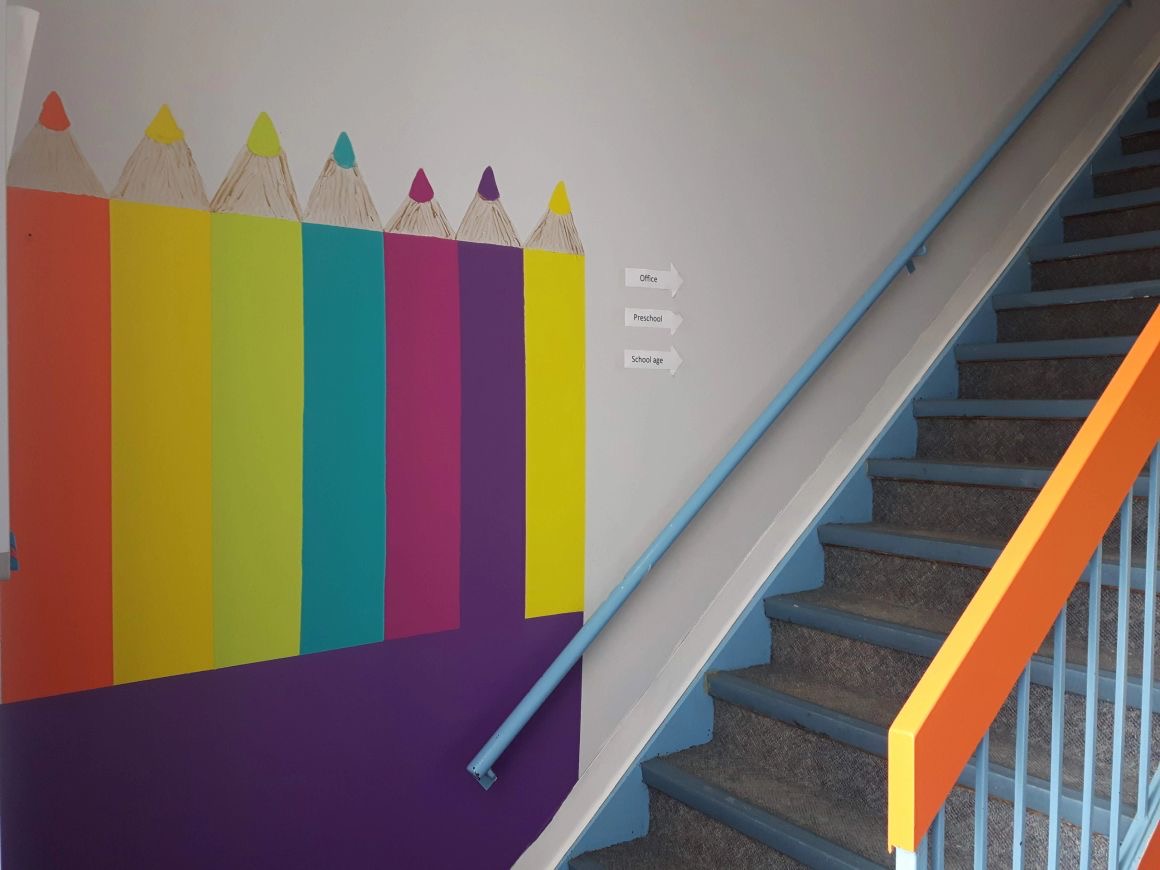 Arnprior hallway with a wall painted as a row of colourful pencils.